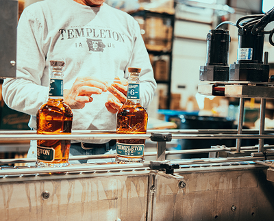 Local hands get to work on our bottling line.